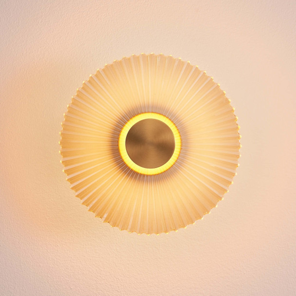 Applique di design dorata con disco plissettato...